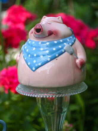 Marlene Olson made this garden art by gluing a pink pig teapot onto a plate and vase.