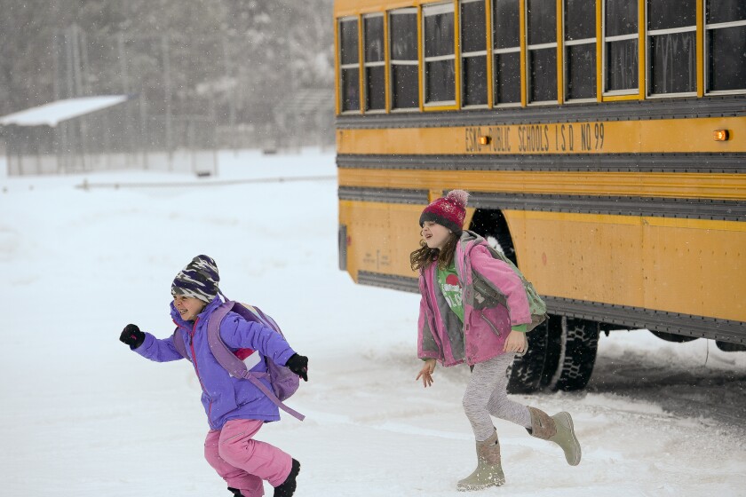 Students race off the bus in anticipation of open hockey skate at Esko