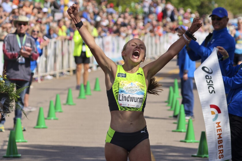 Athletes run and celebrate in the finish area of grandma's marathon
