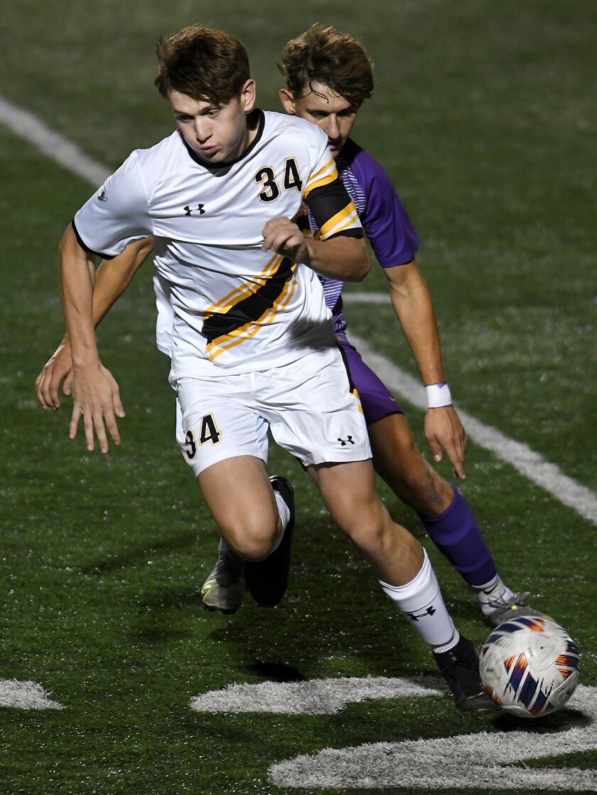 UW-Superior’s Jake Kidd (34) gets around a Northwestern defender