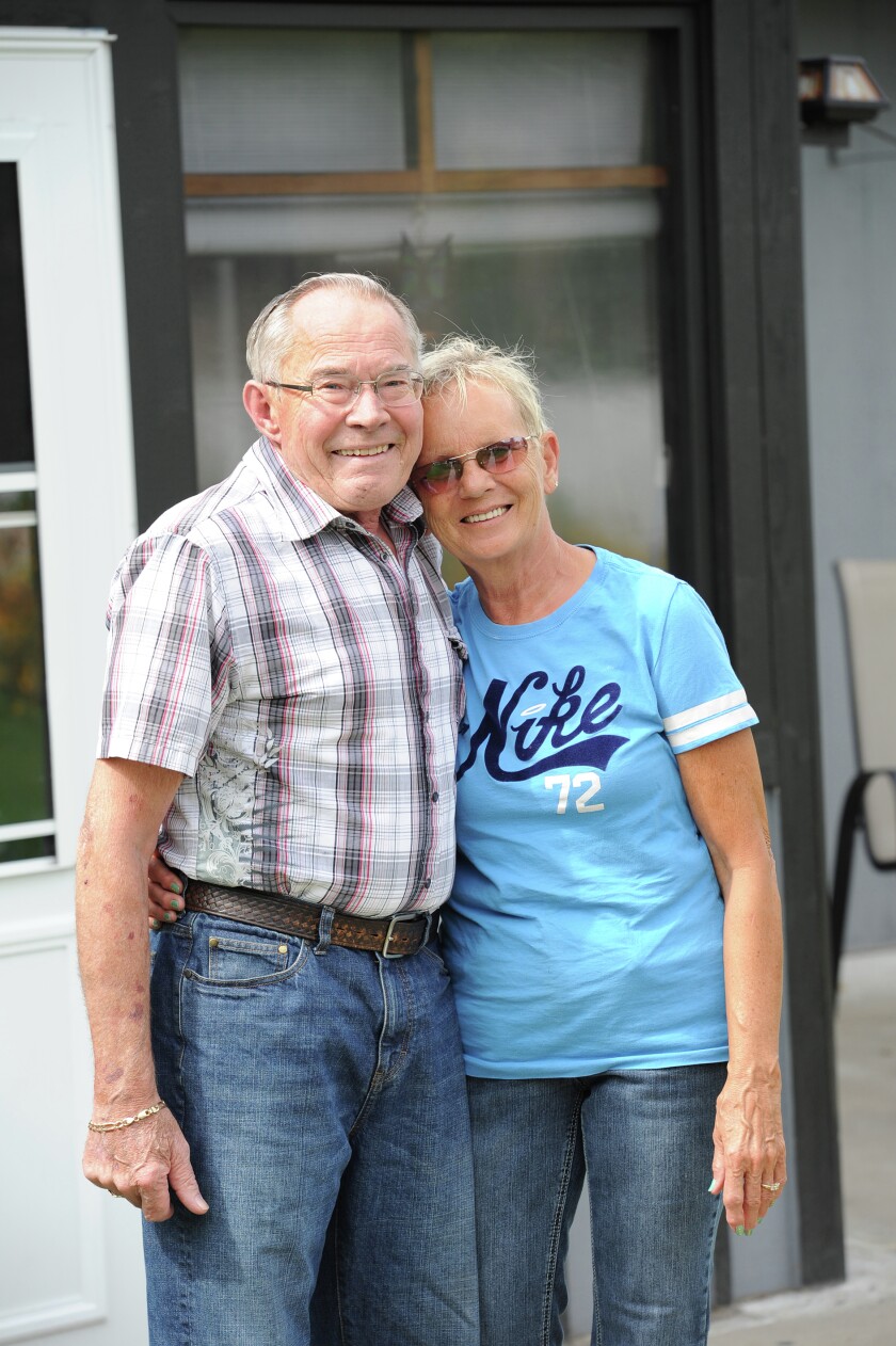 Mayor James Wallin and his wife Minna embrace in the front yard of their Brainerd home Wednesday. James was named 2015 Brainerd Citizen of the Year Tuesday night at the Brainerd City Council meeting. (Brainerd Dispatch/ Steve Kohls)