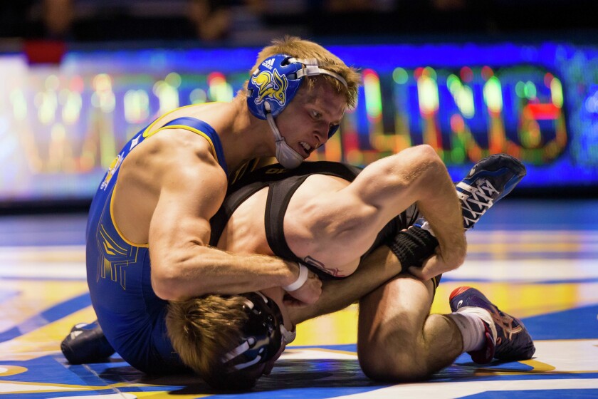 South Dakota State University's Alex Kocer, left, wrestles Iowa's Brandon Sorensen in a 149-pound match Dec. 2, 2016 at Frost Arena in Brookings. (Brad Rempel / USA TODAY Sports)