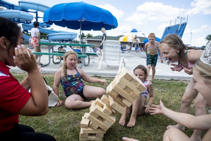 Children react to a crumbling oversized Jenga set while playing mini-games at the Dorothy Olson Aquatic Center during the Queen's Splash on Wednesday, June 22, 2022. The event was one of many on tap for this year's Willmar Fest.