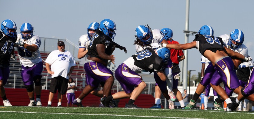 Minnesota West head coach Jeff Linder watches as offense and defense clash as the team runs a first and goal practice live action drill Wednesday afternoon.