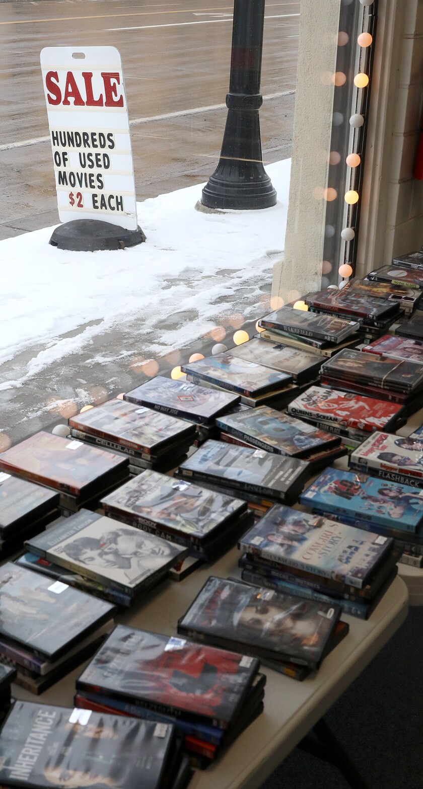 A sign sits outside of Video Vision along Belknap Street