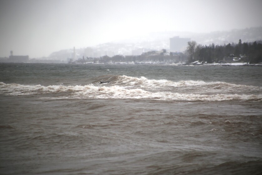 Man attempts to surf the waves.