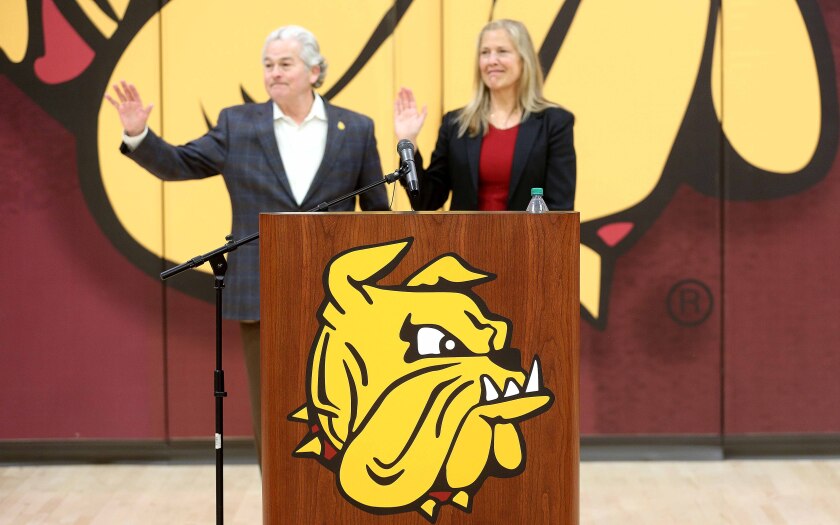 Gary Holquist and Karen Stromme wave