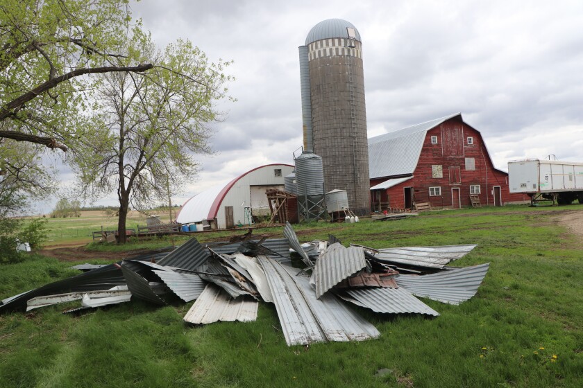 Roof tin from lies in a pile after the the building that had been blown to pieces has been dismantled and carried away on a farm near Volga, South Dakota.