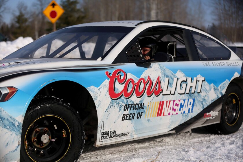 Man sitting in a racecar.