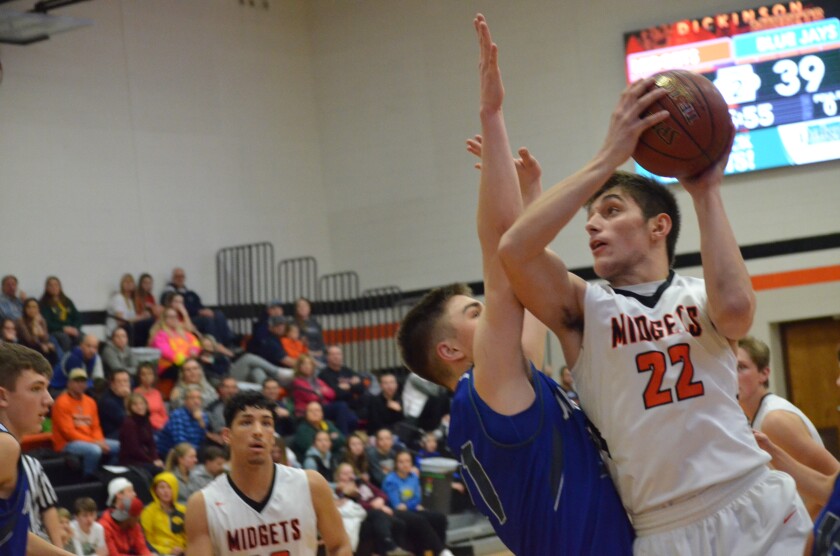 Dickinson High senior forward Krew Mathern attempts a shot with Jamestown sophomore forward Boden Skunberg defending on Friday, Jan. 12 from DHS gym. (Patrick Bernadeau/The Dickinson Press)
