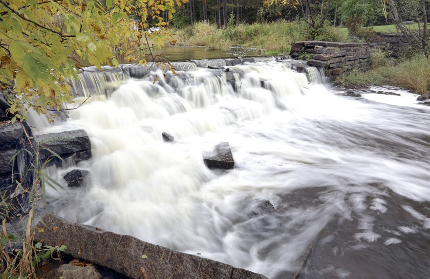 Water flows over a dam.