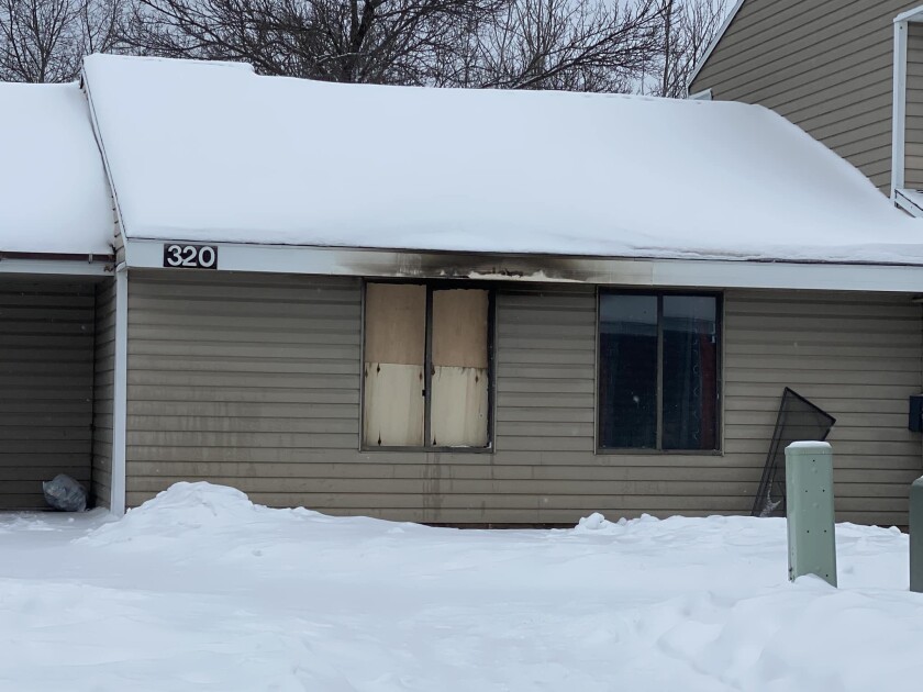 fire-damaged residence in snowy landscape