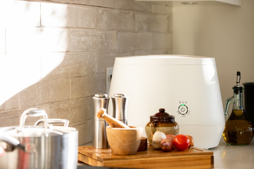 A Lomi countertop compost machine is shown in the kitchen. 