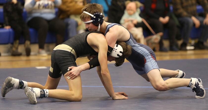 Superior’s Gage Rusk tries to gain control of Hayward’s Carter Roach