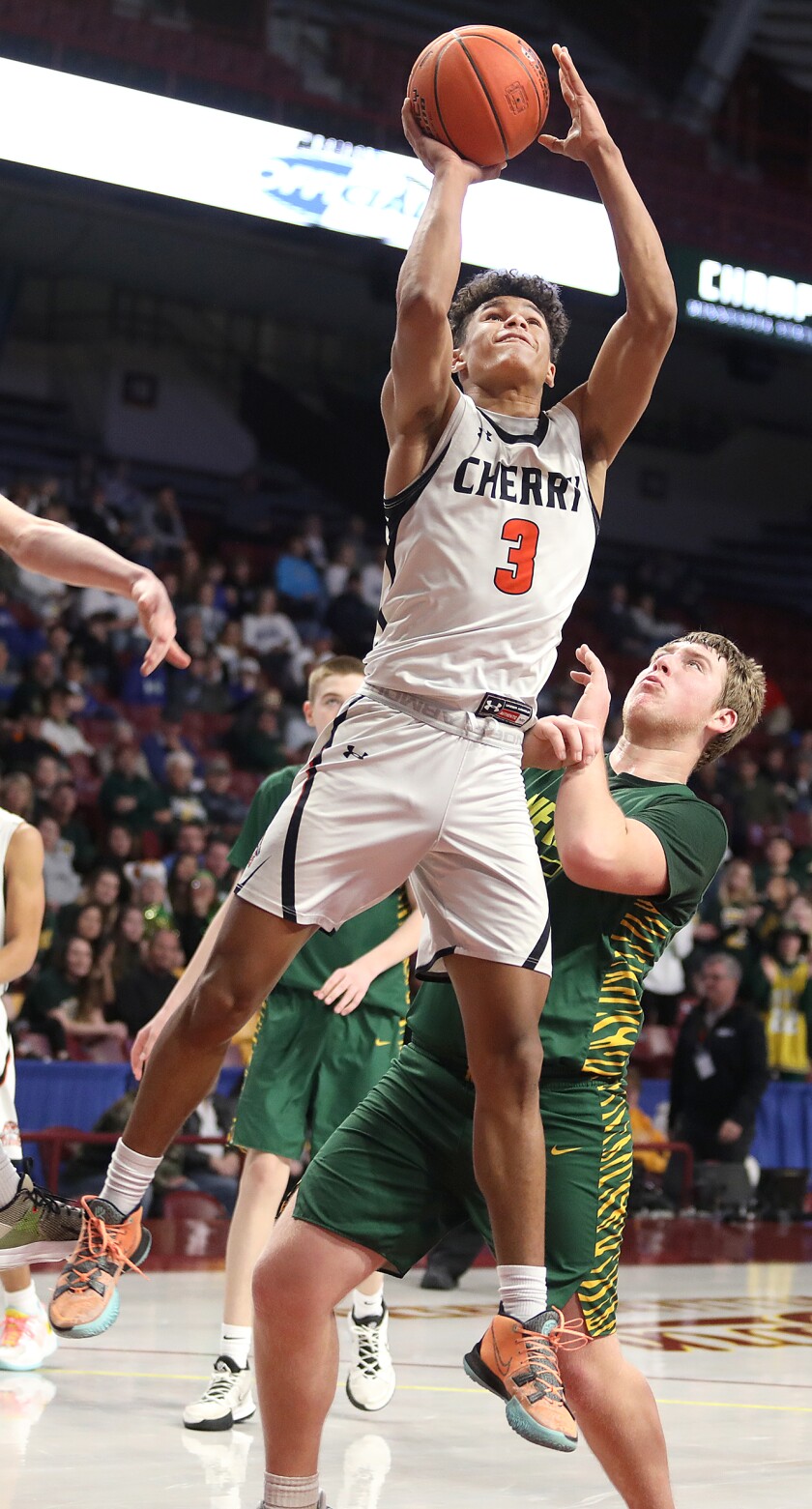 Cherry’s Isaac Asuma (3) goes up for a bucket over Nevis’ JohnPaul Benson (15)