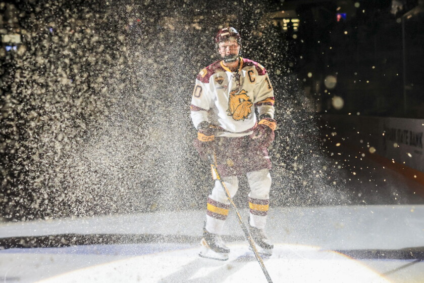 college men play ice hockey indoors