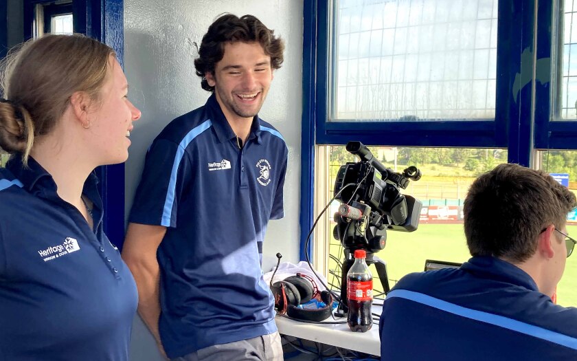 Member of the Duluth Huskies broadcast team laughing