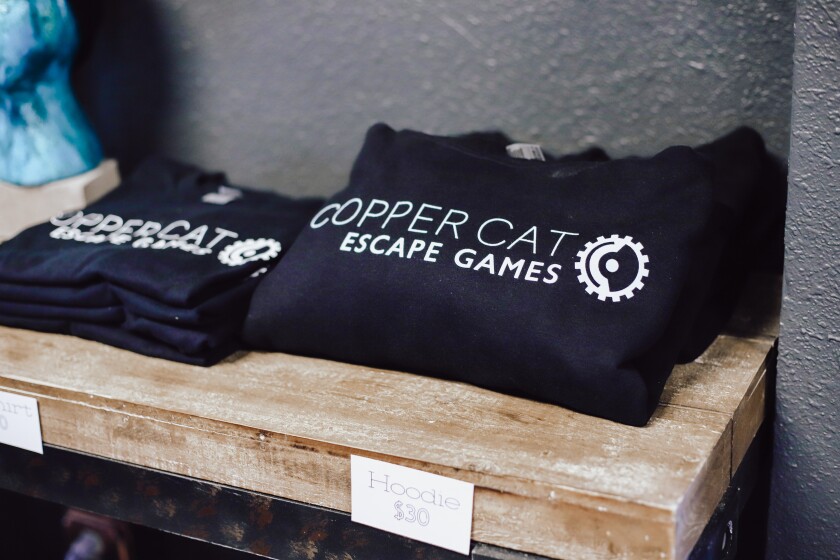 Hoodies and shirts that say Copper Cat Escape Games on them for sale.