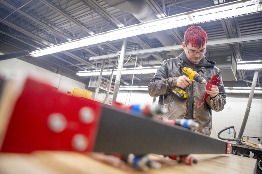 Willmar High School junior Kole Lindemann works on making hooks for a climber during an afterschool gathering on Wednesday, Feb. 23, 2022.