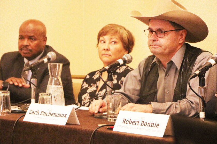 Three top U.S. Department of Agriculture heads -- an African American man, a woman with Asian