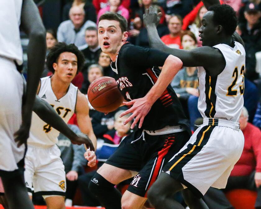 Rochester John Marshall’s Matthew Hurt (1) makes a move to the basket on Mankato East’s Uhana Ochan (23) on Feb. 13, 2018 in Rochester, Minnesota. Hurt and the Rockets will be one of the top teams to appear at the Hoop City Classic this December. (Andrew Link / Rochester (Minn.) Post Bulletin)