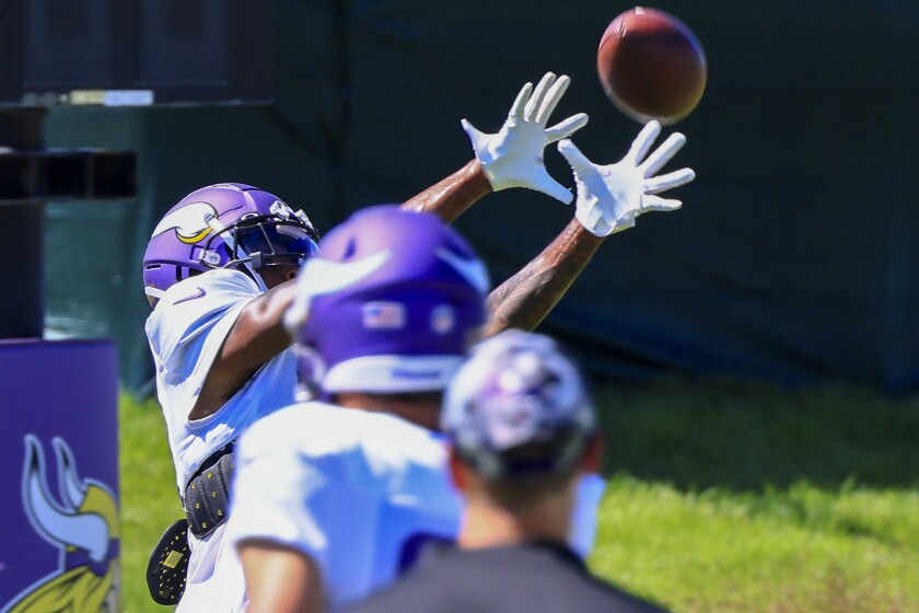 Professional football players practice at outdoor field