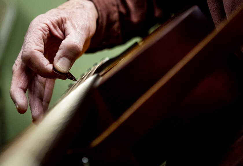 Steven Streng of St. Joseph tunes his guitar at the start of a free fiddle workshop at Hope Lutheran Church in Sunburg on Sunday, April 3, 2022.