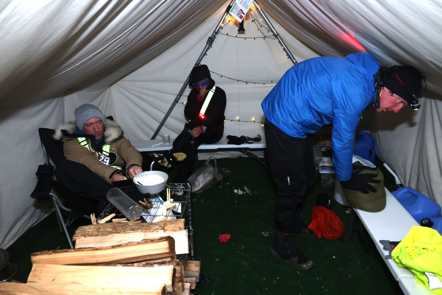 Ultramarathoners rest inside checkpoint tent