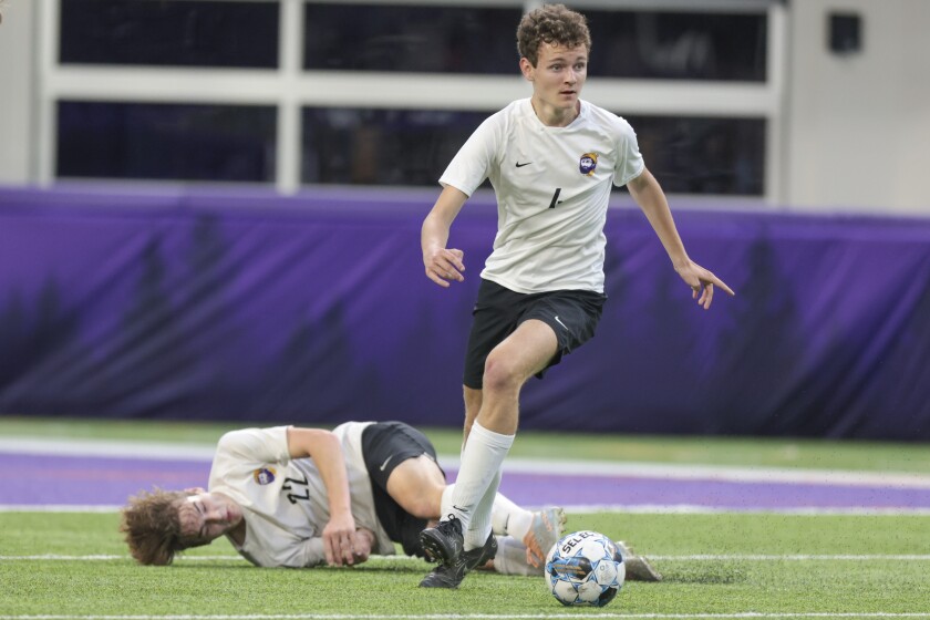 boys soccer players playing in indoor stadium