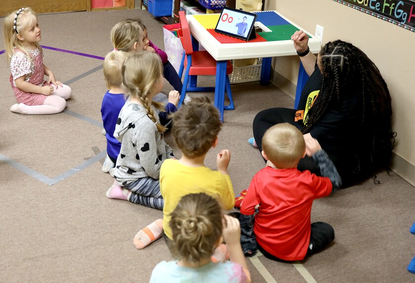 The four year old room works on sign language