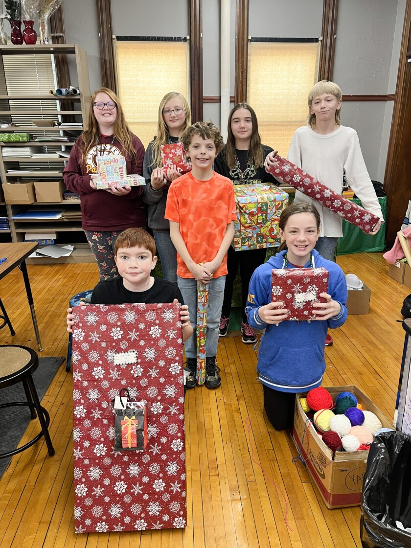 Students at Ellsworth Public School show the presents from the Share Tree on Tuesday, Dec. 20, 2022.