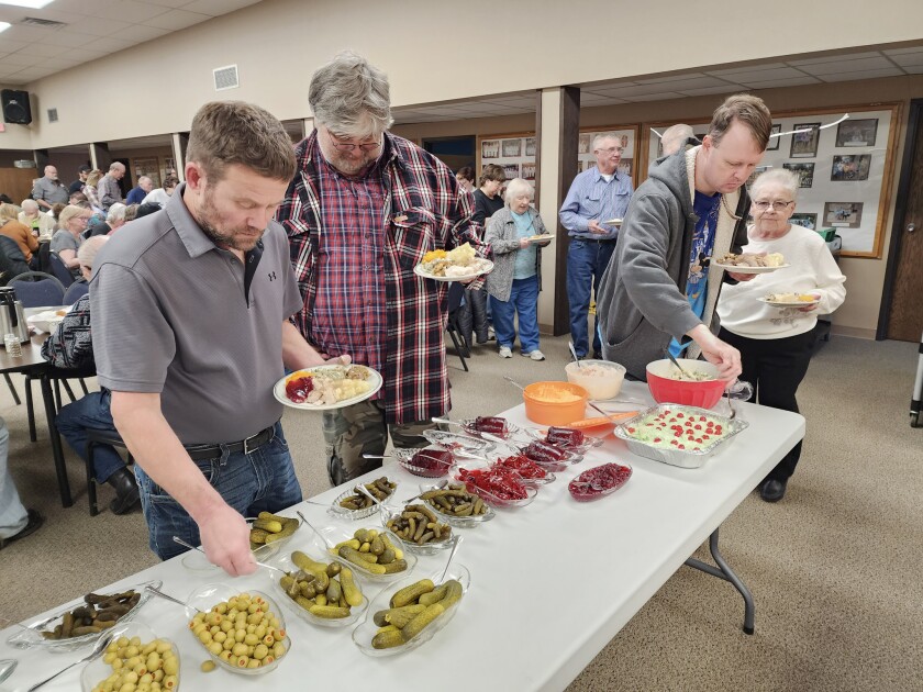 Guests at the Community Thanksgiving Dinner dip into the relish trays, filled with pickles, olives and cranberry sauce on Thursday, Nov. 24, 2022, at First Lutheran Church in Worthington.