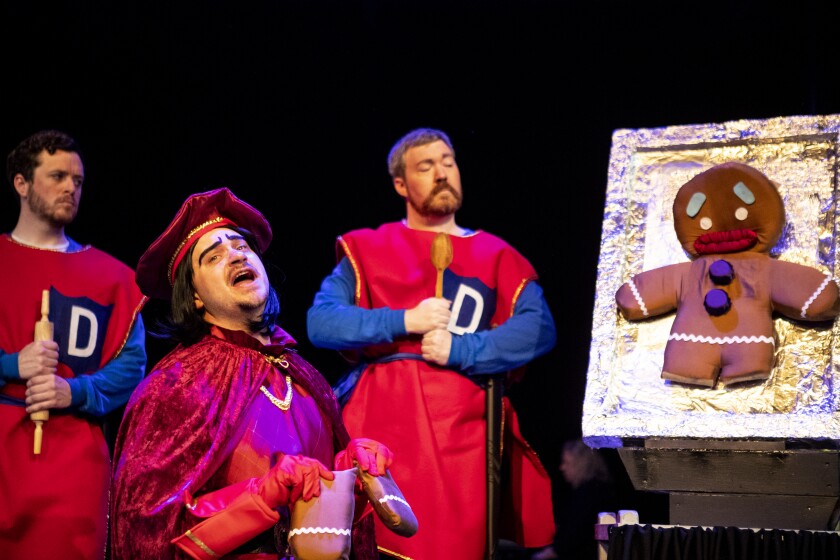 Lord Farquaad takes the legs of Gingy the gingerbread man during a royal interrogation a dress rehearsal of Shrek the Musical at the Barn Theatre on Saturday, June 4, 2022.