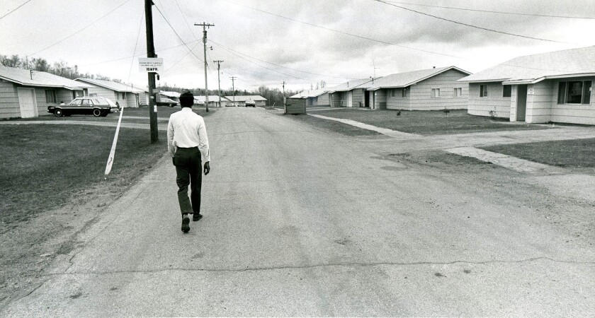 1st Lt. Raymond Crump walks through a nearly empty row of military housing at the Finland Air Force Station