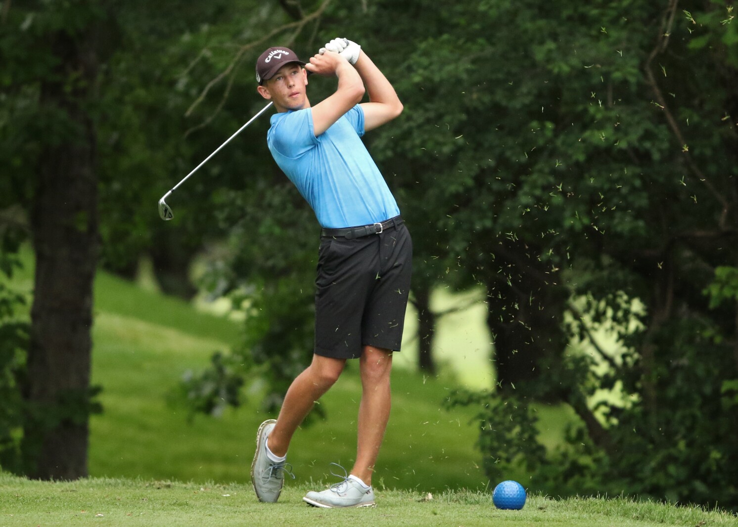 Golfer hits the ball