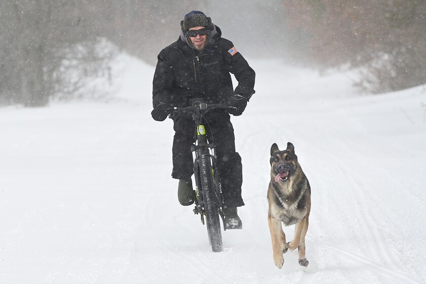 Man riding bicycle in snow