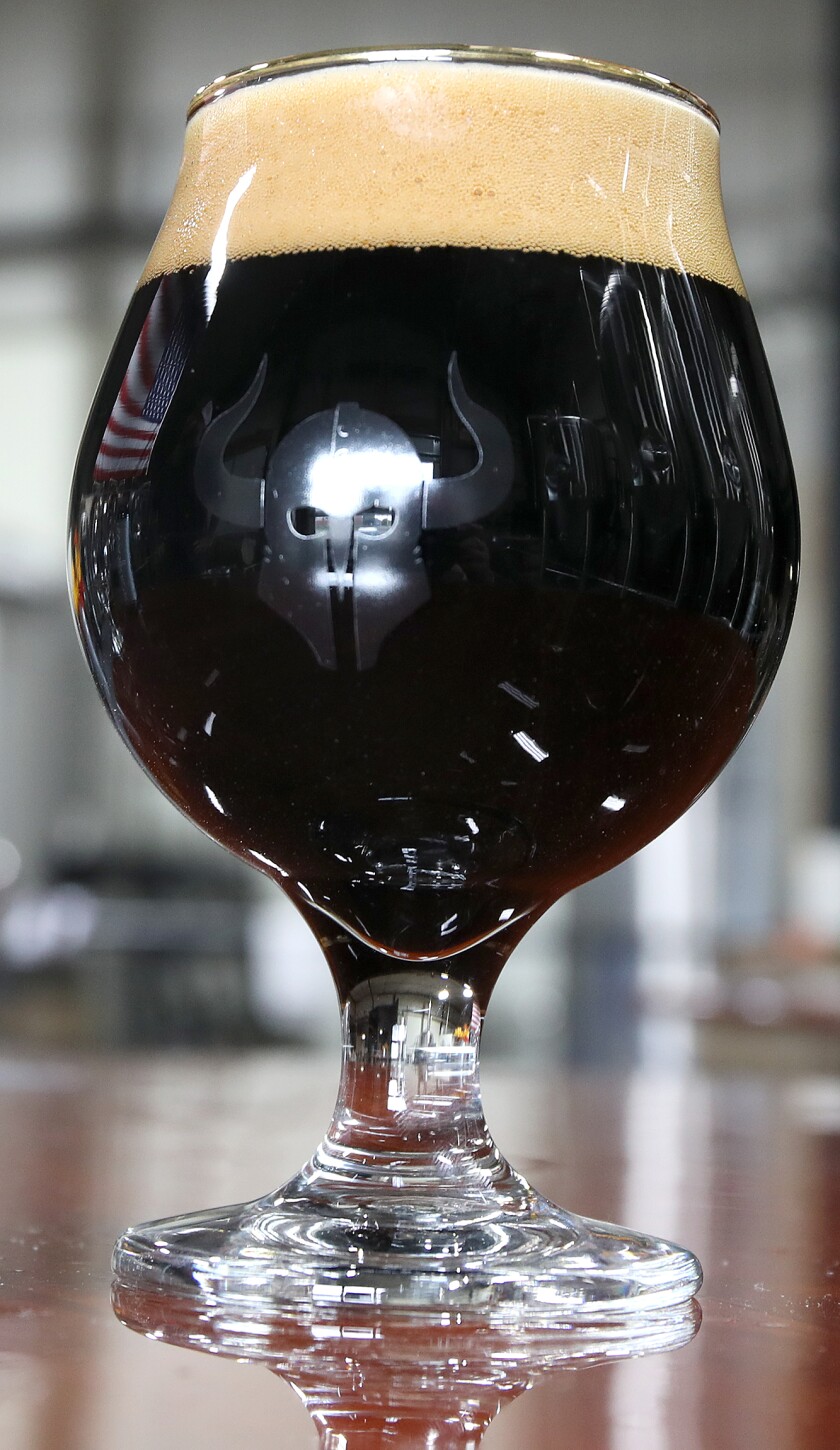 A glass of the award winning Barbarian Imperial Stout sits on a table in the tap room at Warrior Brewing Company in Duluth