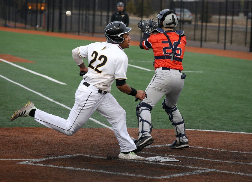 UW-Superior’s Jordan Trimble (22) beats a throw to home