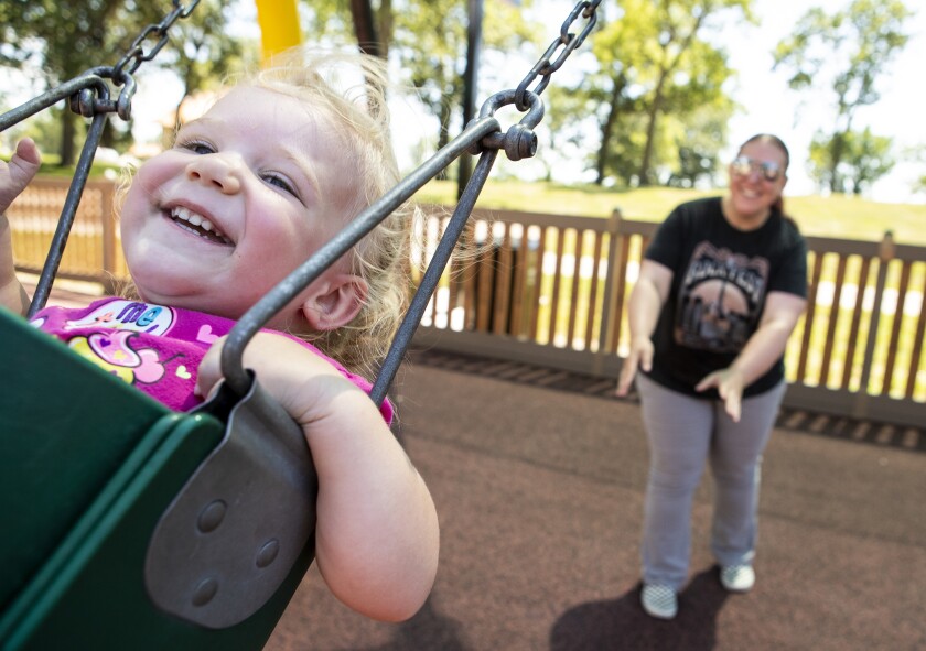 Mother April Clark, at right, pushes Rachel Clark, 2, on the swings at the Willmar Destination Playground at Robbins Island Regional Park on Thursday, July 14, 2022.