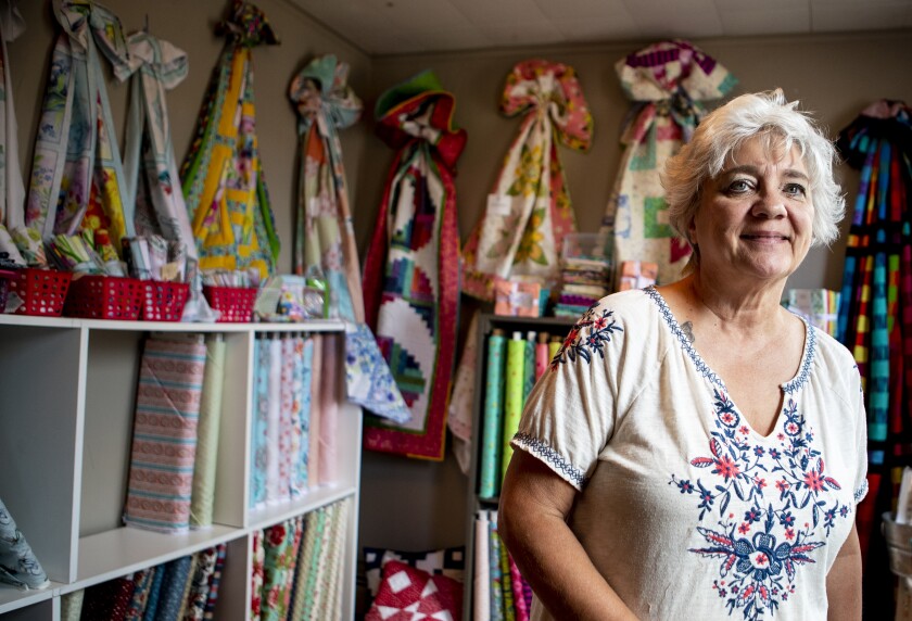 New London-based quilt store owner Linda Lagergren of Paisley Threads stands inside her colorful shop full of quilts, thread and fabric on Thursday, July 28, 2022.