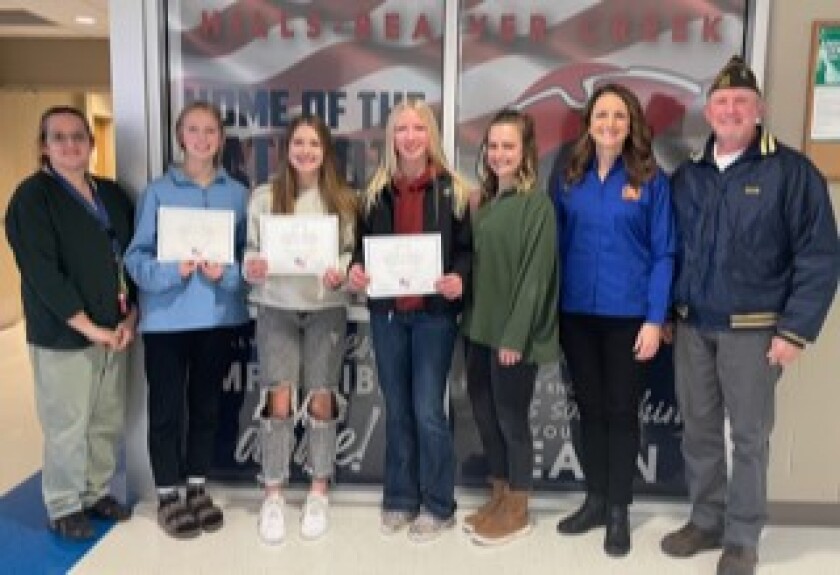 From left, Megan Klumper; Avril Ty Suzie, who earned first place in the "Voice of Democracy" competition; Hailey Moser, who took third place in the "Patriot's Pen" contest; Brynn Bakken, who earned second place in the "Patriot's Pen" competition; Lydia Scruggs; Gina Newman and Robert Newman celebrate the winners of the Wilmont VFW and VFW Auxiliary contests.