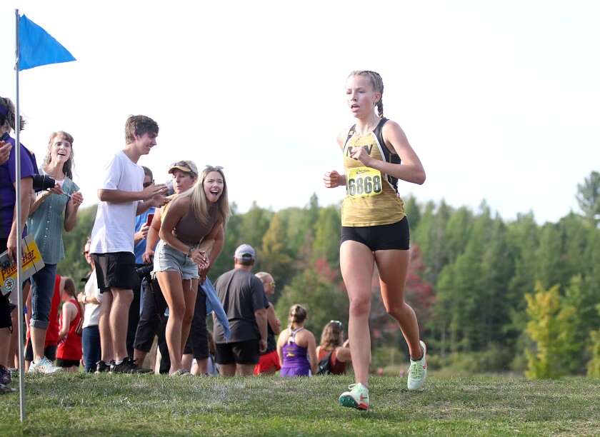 Northwestern’s Jenna Hursh (6868) gets cheered on by the crowd on her way to a second place finish