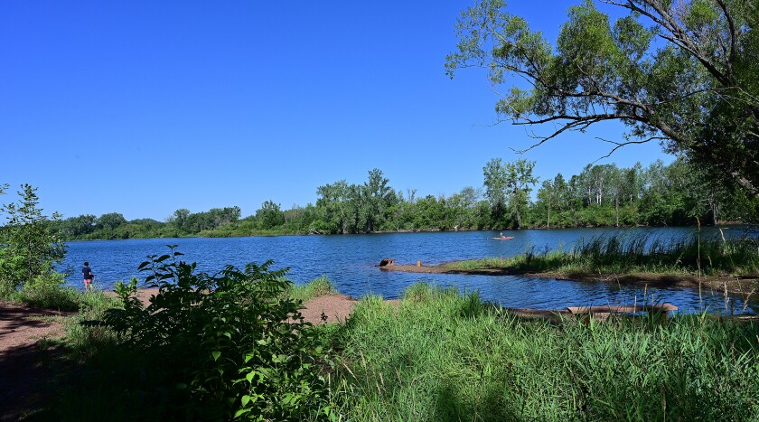 A lake next to the True North Basecamp in Crosby reflects sunlight from the body of water.