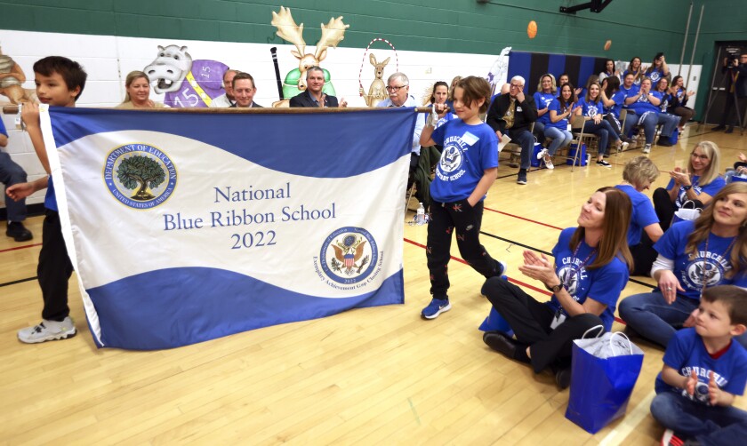 Two boys carry a banner.
