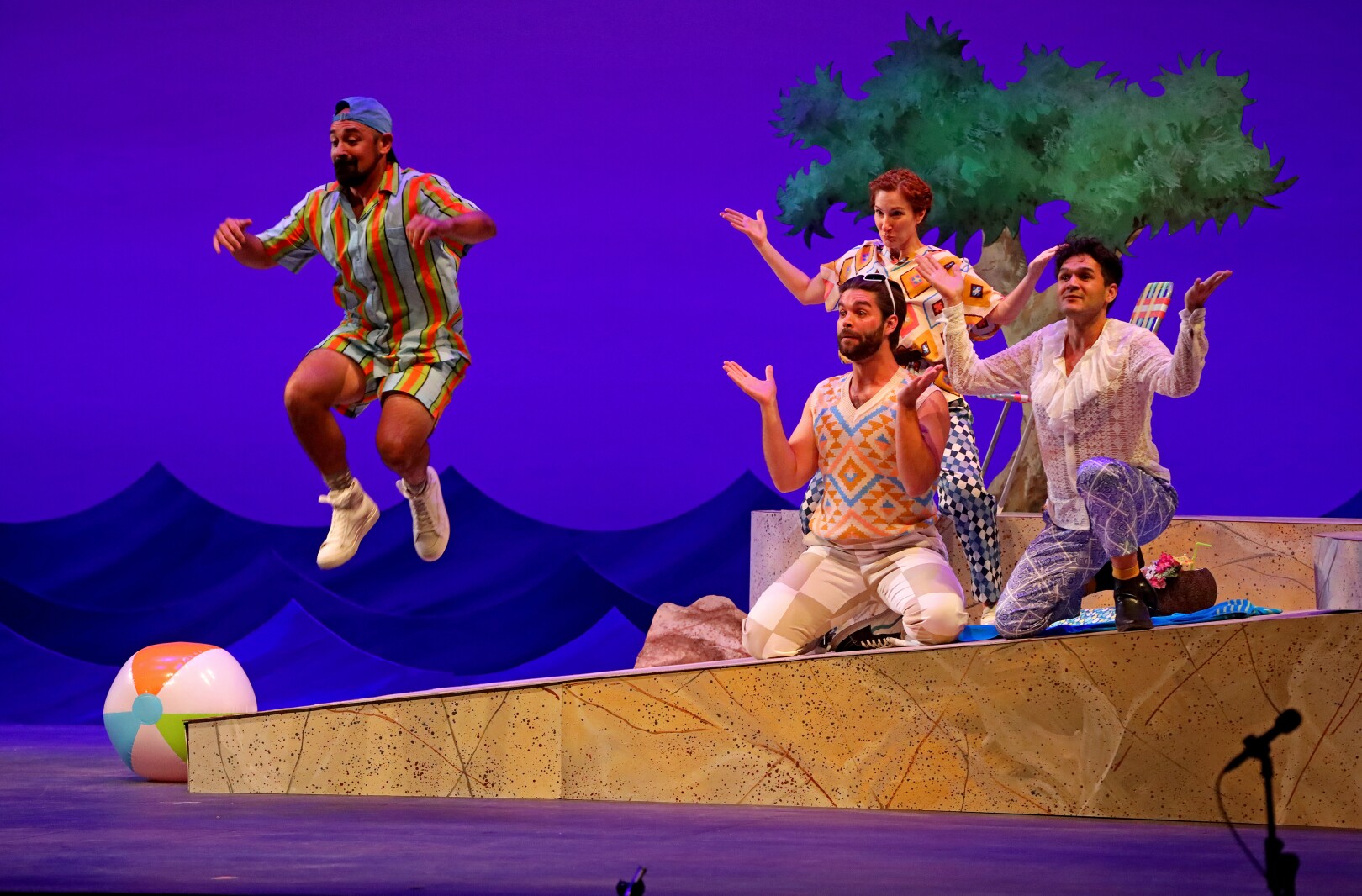 Actors perform on stage.