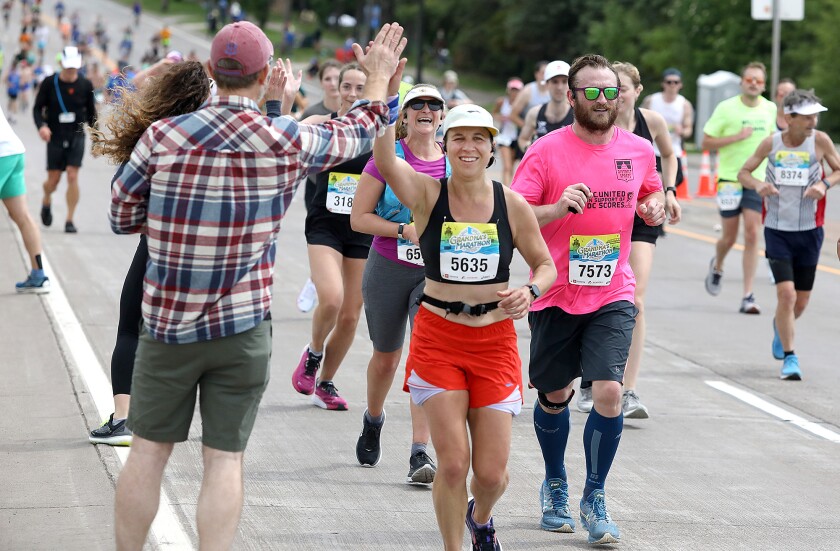 Emily Francis (5635) gives a high five to Nate Saul, of Minneapolis, as she gets to the top of Lemon Drop Hill