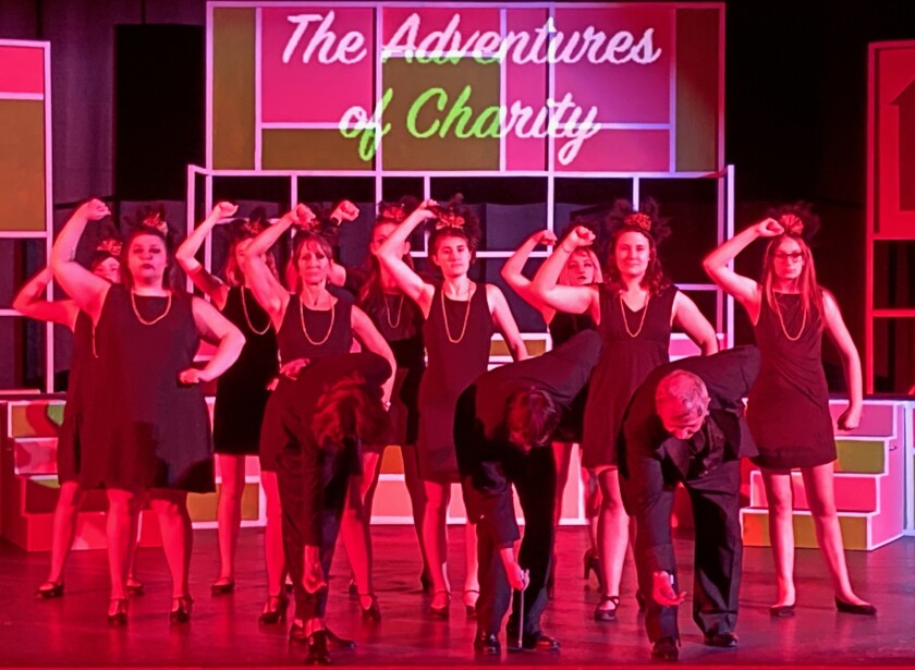 People dancing on stage during a musical production.