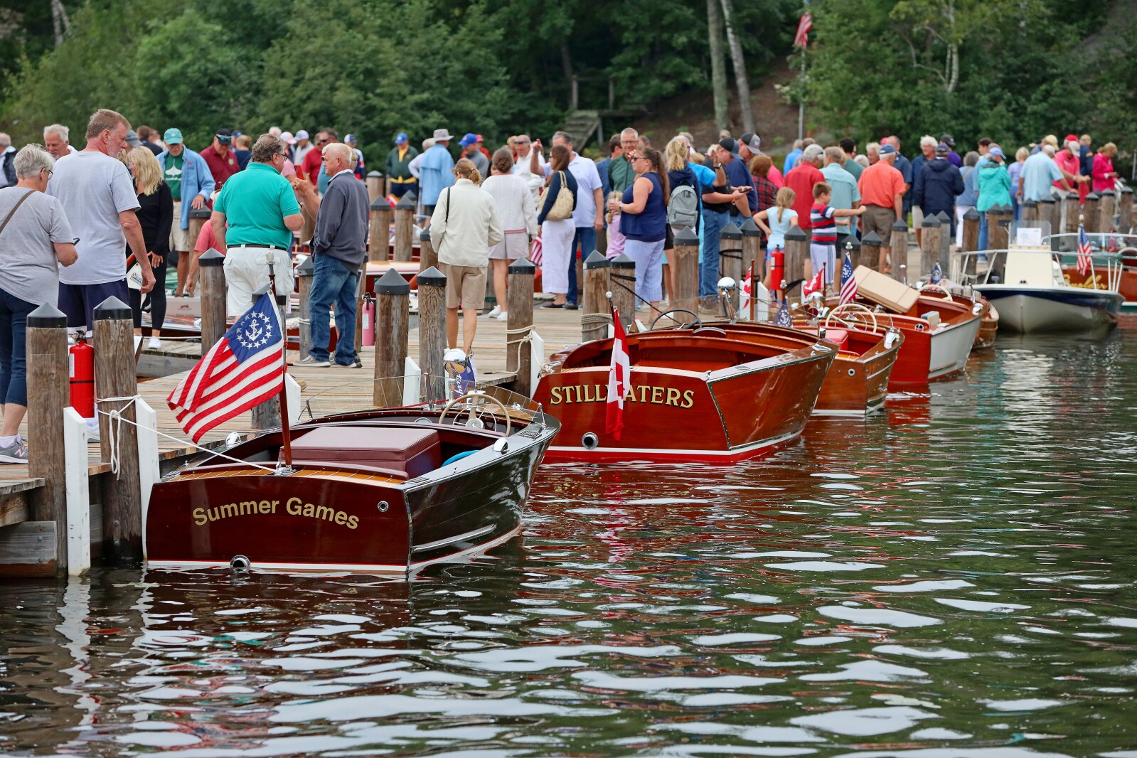 Attendees admire classic boats on display Saturday, Aug. 27, 2022, during the annual Classic Boat Show at the Bar Harbor Supper Club in Lake Shore.