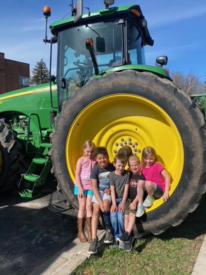 Osakis elementary students check out one of the tractors the high school students drove to school on May 20.