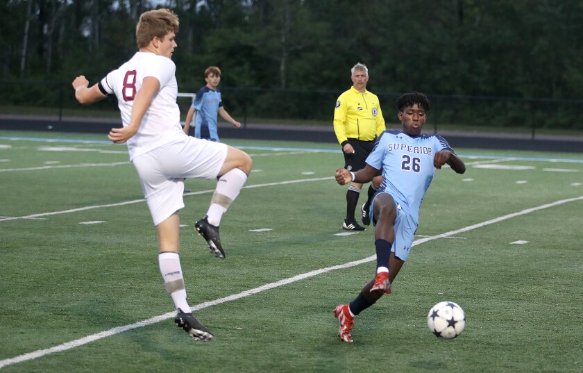 Superior’s Dancha Stauber (26) maintains control of the ball in front of Duluth Denfeld’s Parker Chastey (8)